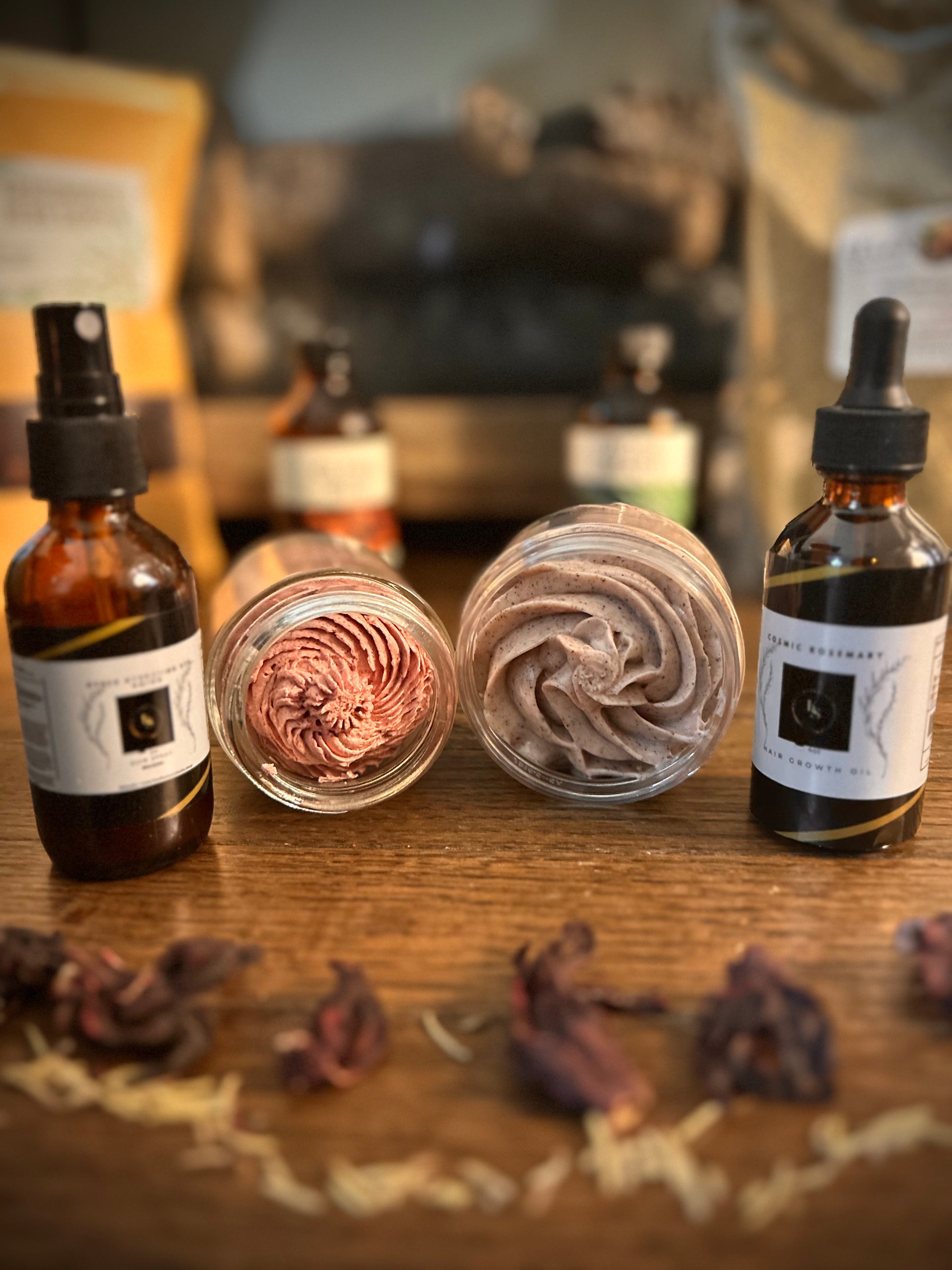 Organic skincare products on a wooden surface with dried flowers scattered around.